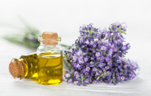 two essential oils glass bottles with lavender flowers