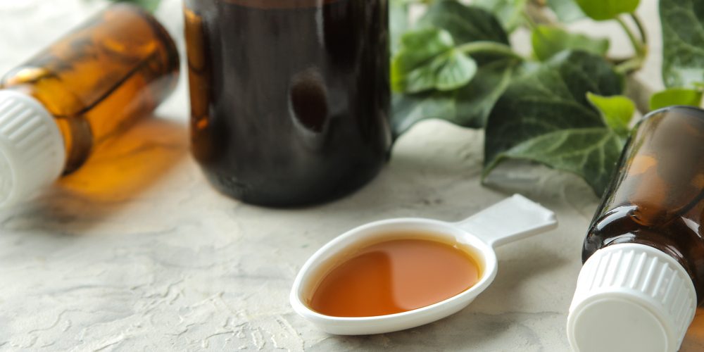 A,Leaf,Of,Ivy,And,Syrup,In,A,Bottle,On Essential oil for cough