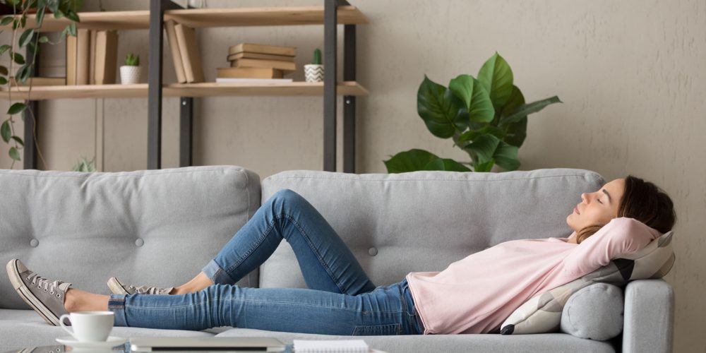 a woman power napping on sofa