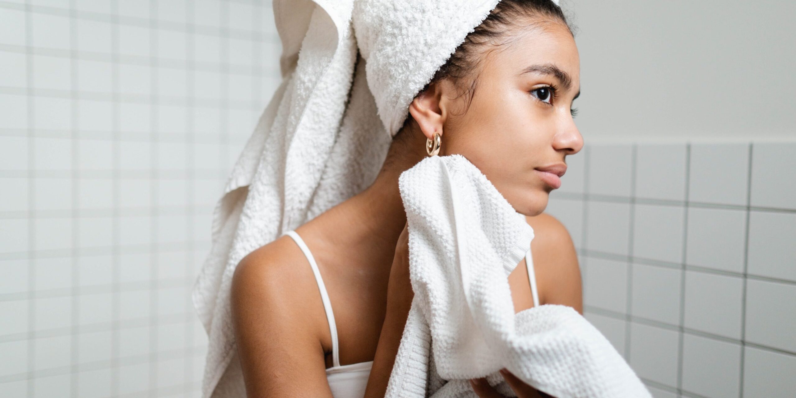 woman cleaning face with towel