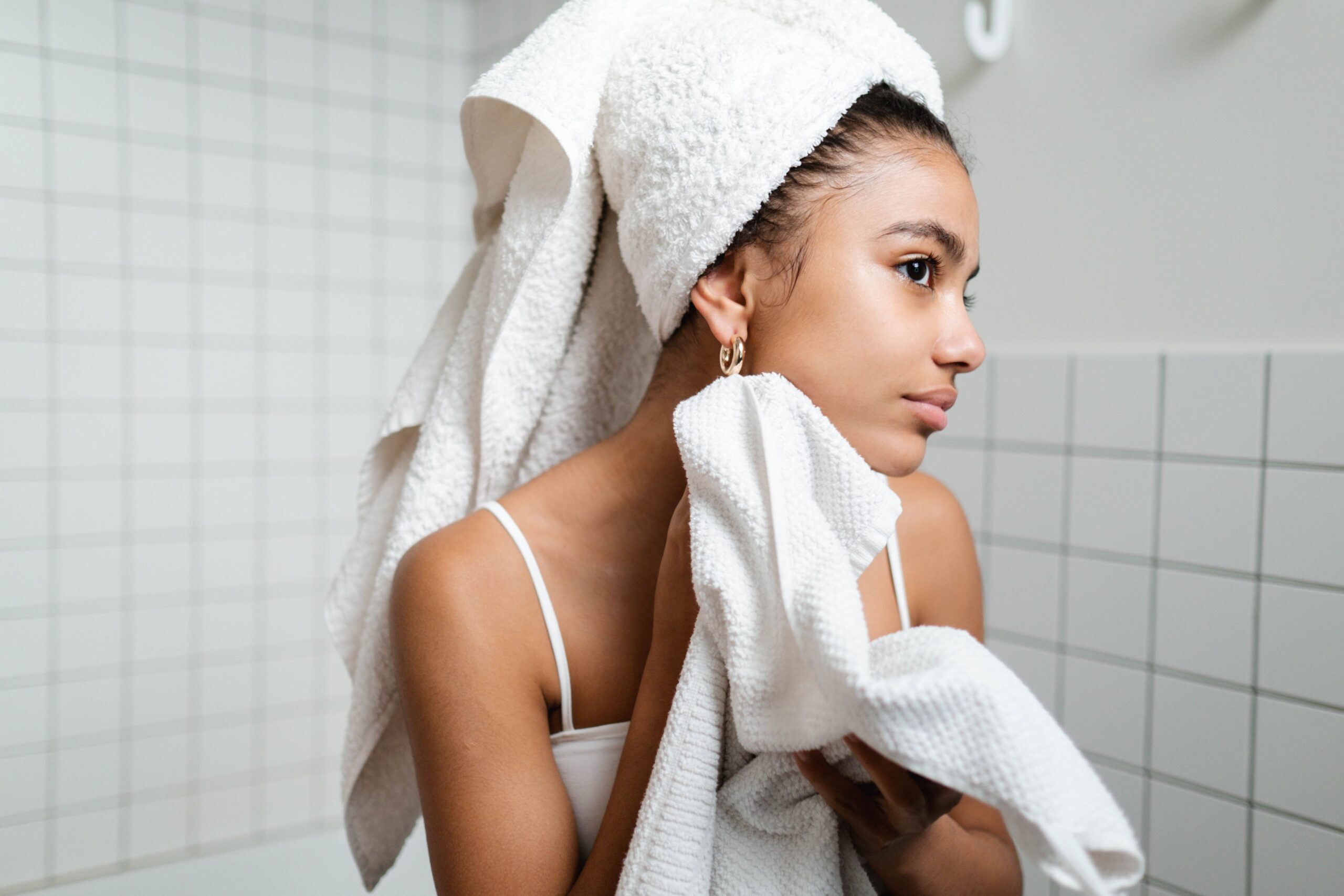 woman cleaning face with towel